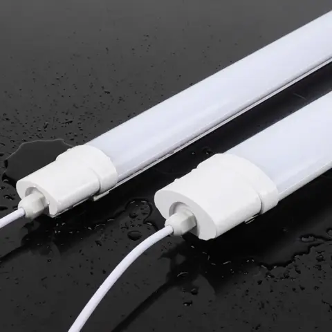 WaBrite IP65 LED Tri-Proof Light dual aluminum linear industrial batten fixtures on water splashed surface showing water resistance