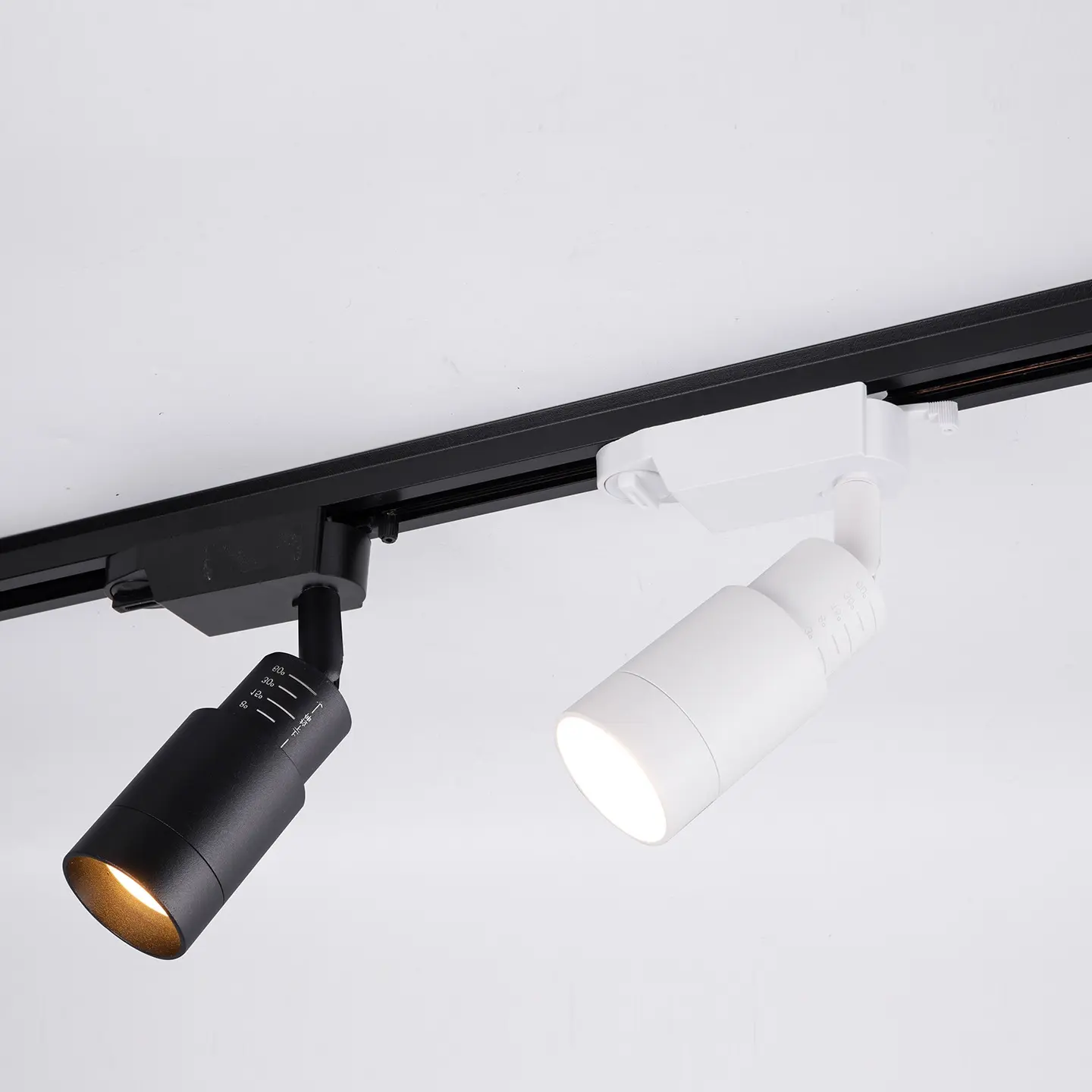 Modern adjustable LED track light, black and white finishes.