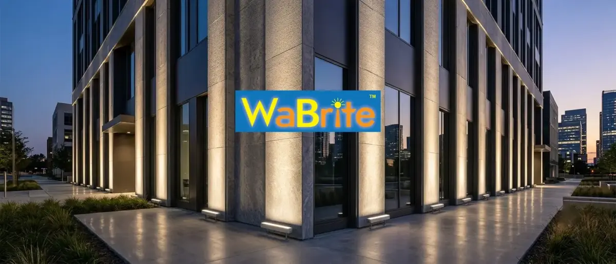 Linear LED wall washer lighting installed on a modern commercial office building facade at dusk.